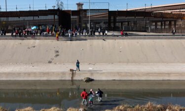 Immigrants cross the Rio Grande into El Paso