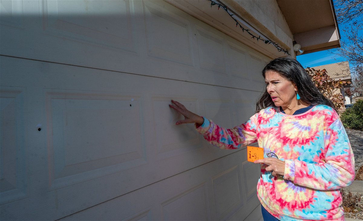 <i>Adolphe Pierre-Louis/The Albuquerque Journal/AP</i><br/>State Sen. Linda Lopez shows bullet holes in her garage door after her home was shot at on January 3 in Albuquerque