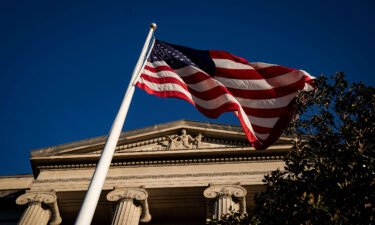 An American flag is seen outside the Department of Justice building in Washington