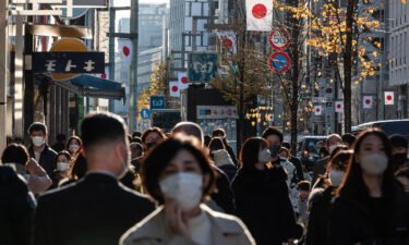 Pedestrians walk along a street in Tokyo's Ginza district on December 29