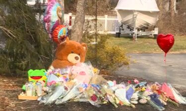 A Massachusetts mother accused in connection with the deaths of her three children remains hospitalized as she is treated for injuries suffered when she jumped from a window of her Duxbury home.