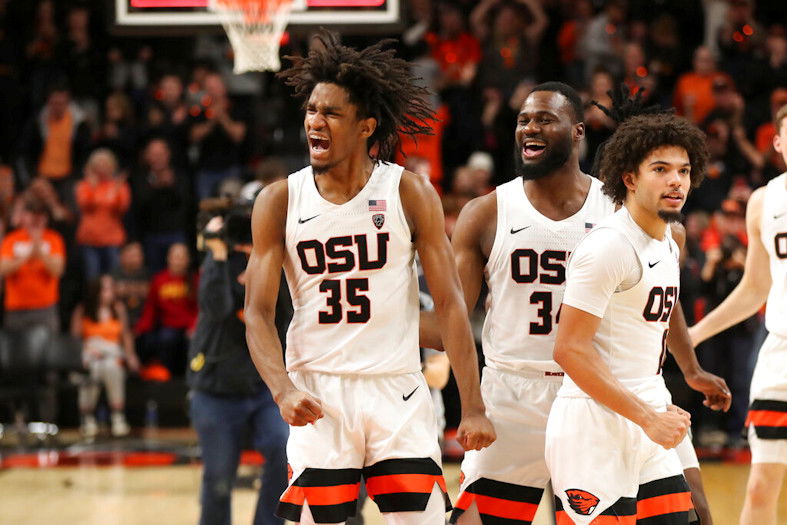 Oregon State's Glenn Taylor Jr., left, Rodrigue Andela, center, and Jordan Pope, right, celebrate after their win over Southern Cal on Saturday in Corvallis