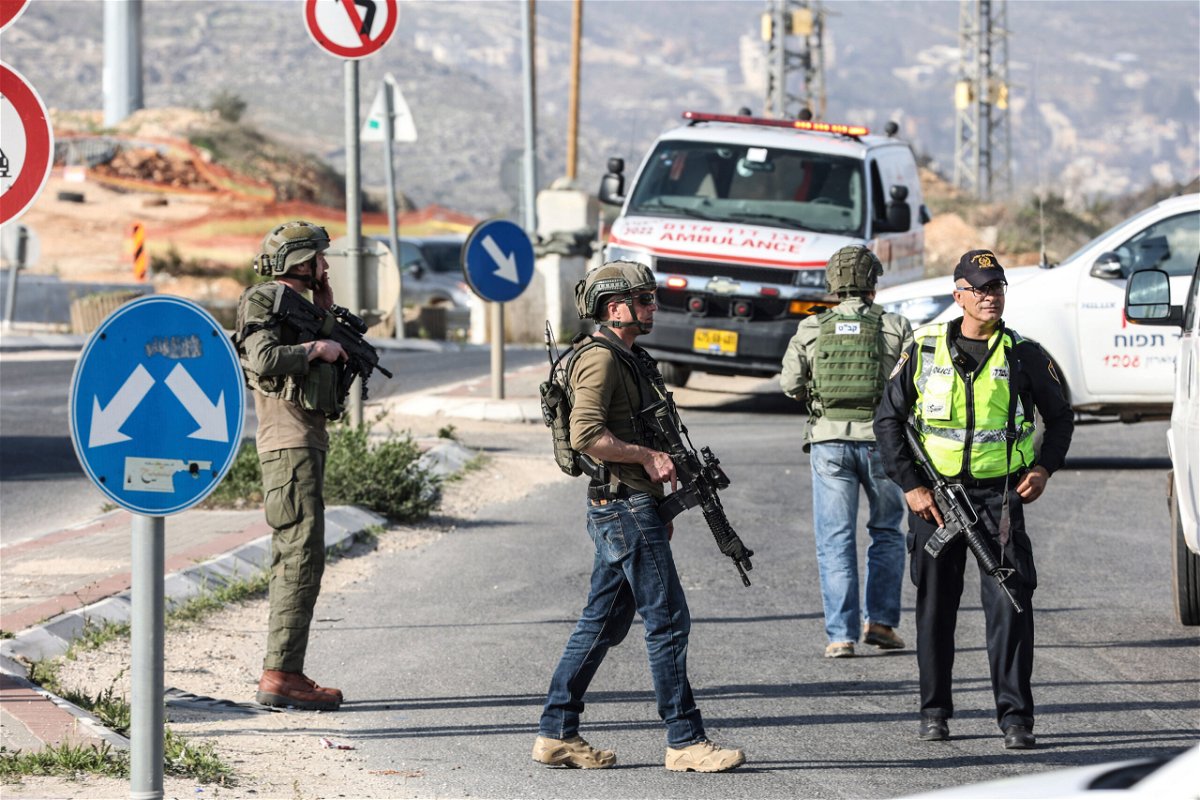 <i>Ilia Yefimovich/dpa/AP</i><br/>Israeli security forces close the road and search for a shooter following a shooting attack in Hawara area.
