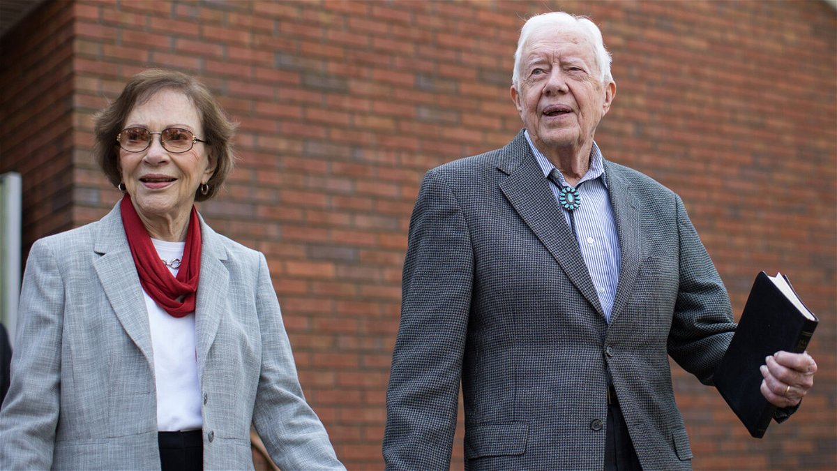 <i>Branden Camp/AP</i><br/>Former President Jimmy Carter walks with his wife Rosalynn after teaching Sunday School class in Plains