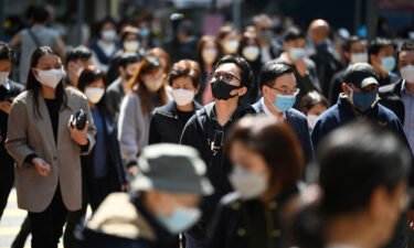 People wear masks on a street in Hong Kong on February 27.