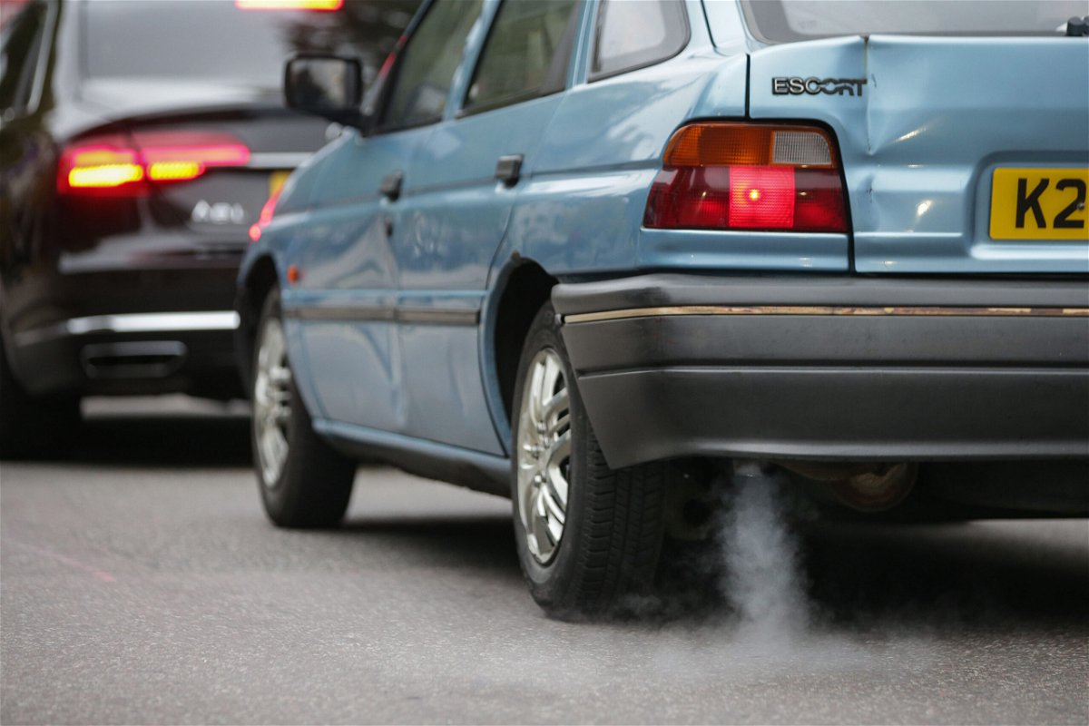 <i>Daniel Leal-Olivas/AFP/Getty Images</i><br/>A car emits fumes from its exhaust as it waits in traffic in central London
