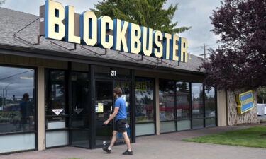A man returns rented DVDs to the last remaining Blockbuster video store is seen in Bend