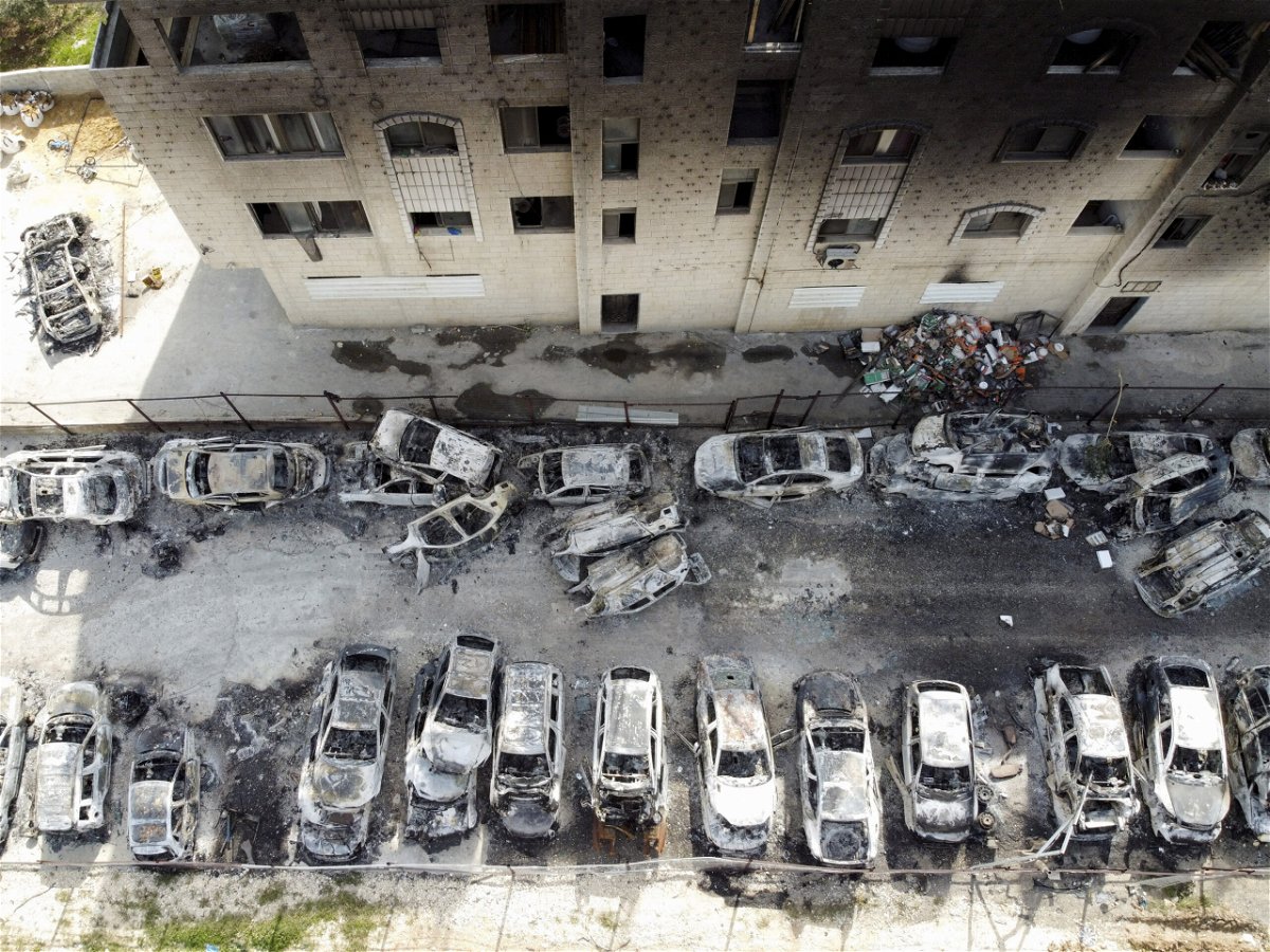 <i>Ammar Awad/Reuters</i><br/>An aerial view shows a building and cars burnt in an attack by Israeli settlers
