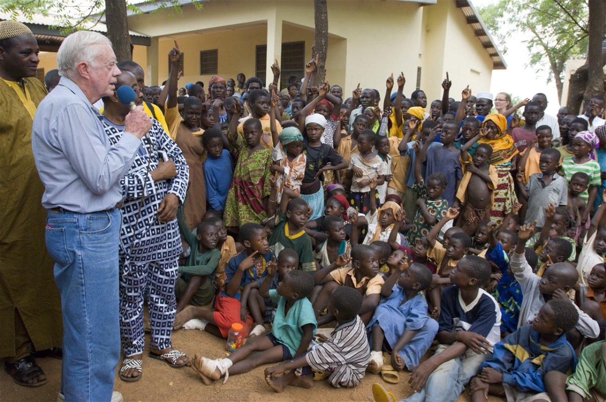 <i>Courtesy Carter Center</i><br/>resident Jimmy Carter and his wife Rosalynn address Savelugu children on the seriousness of eradicating guinea worm disease.