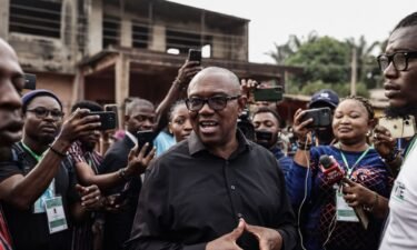Labour Party presidential candidate Peter Obi (center) talks to the media outside a polling station in Amatutu on February 25