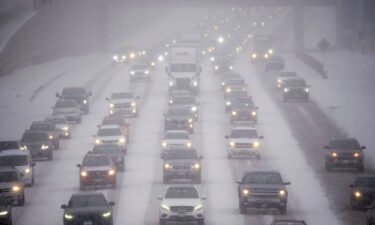 Rush hour traffic travels southbound on Interstate 35W in Minneapolis as a winter storm began hitting the Twin Cities on Tuesday.