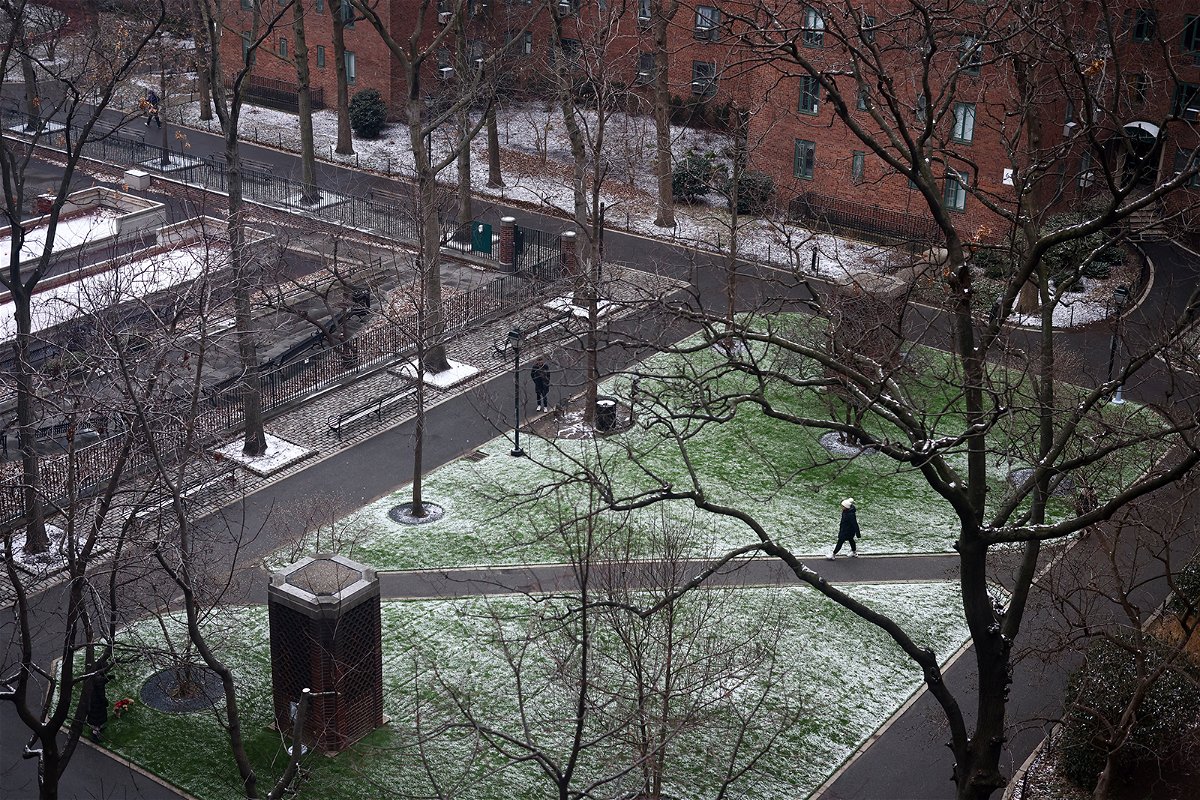 <i>Andrew Kelly/Reuters</i><br/>A person walks through a park following the first measurable snowfall of the season