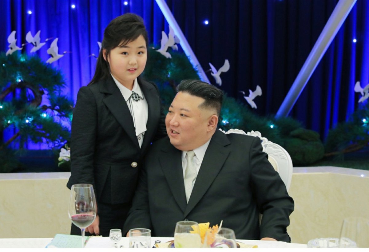 <i>Rodong Sinmun</i><br/>KIm Jong Un is pictured with a girl believed his daughter at a military banquet on Tuesday.