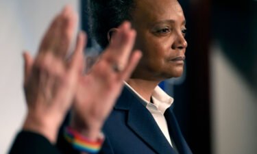 Chicago Mayor Lori Lightfoot pauses during her concession speech as her spouse Amy Eshleman applauds on February 28 in Chicago.