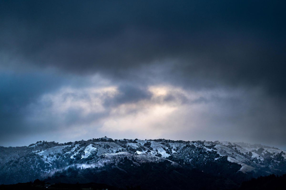<i>Melina Mara/The Washington Post/Getty Images/FILE</i><br/>Clouds hover above a rare accumulation of snow in the mountains of the Los Padres National Forest in Big Sur