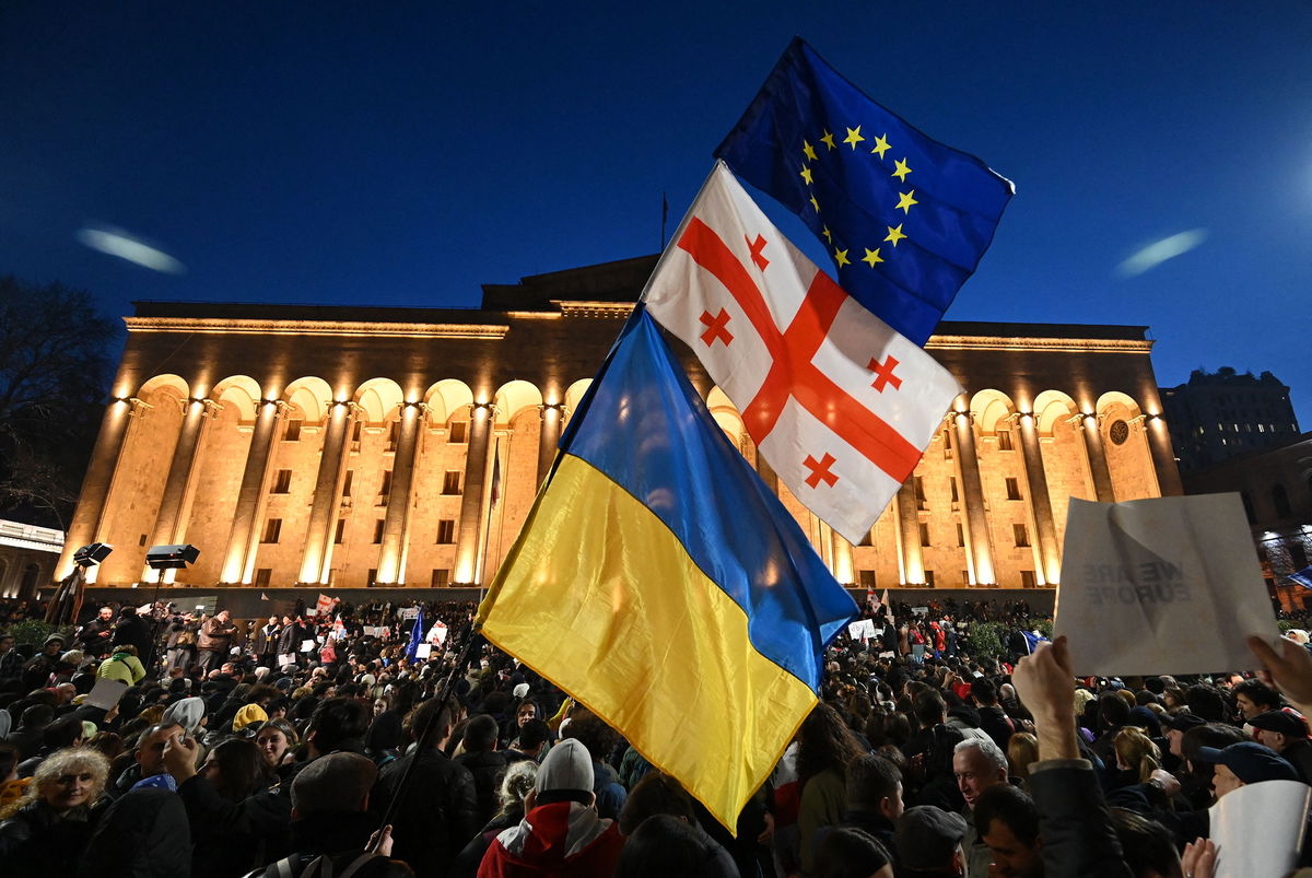 <i>Vano Shlamov/AFP/Getty Images</i><br/>Protesters wave the Georgian