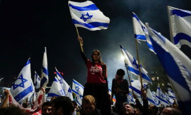 Thousands streamed into central Tel Aviv on Sunday night in support of the fired defense minister