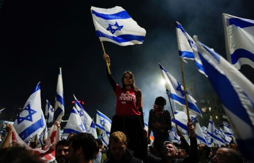 Thousands streamed into central Tel Aviv on Sunday night in support of the fired defense minister