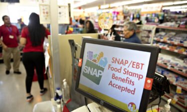 Millions of Americans will lose $3 billion in monthly food stamp benefits starting in March. A "SNAP/EBT Food Stamp Benefits Accepted" sign is displayed inside a Family Dollar store in Chicago