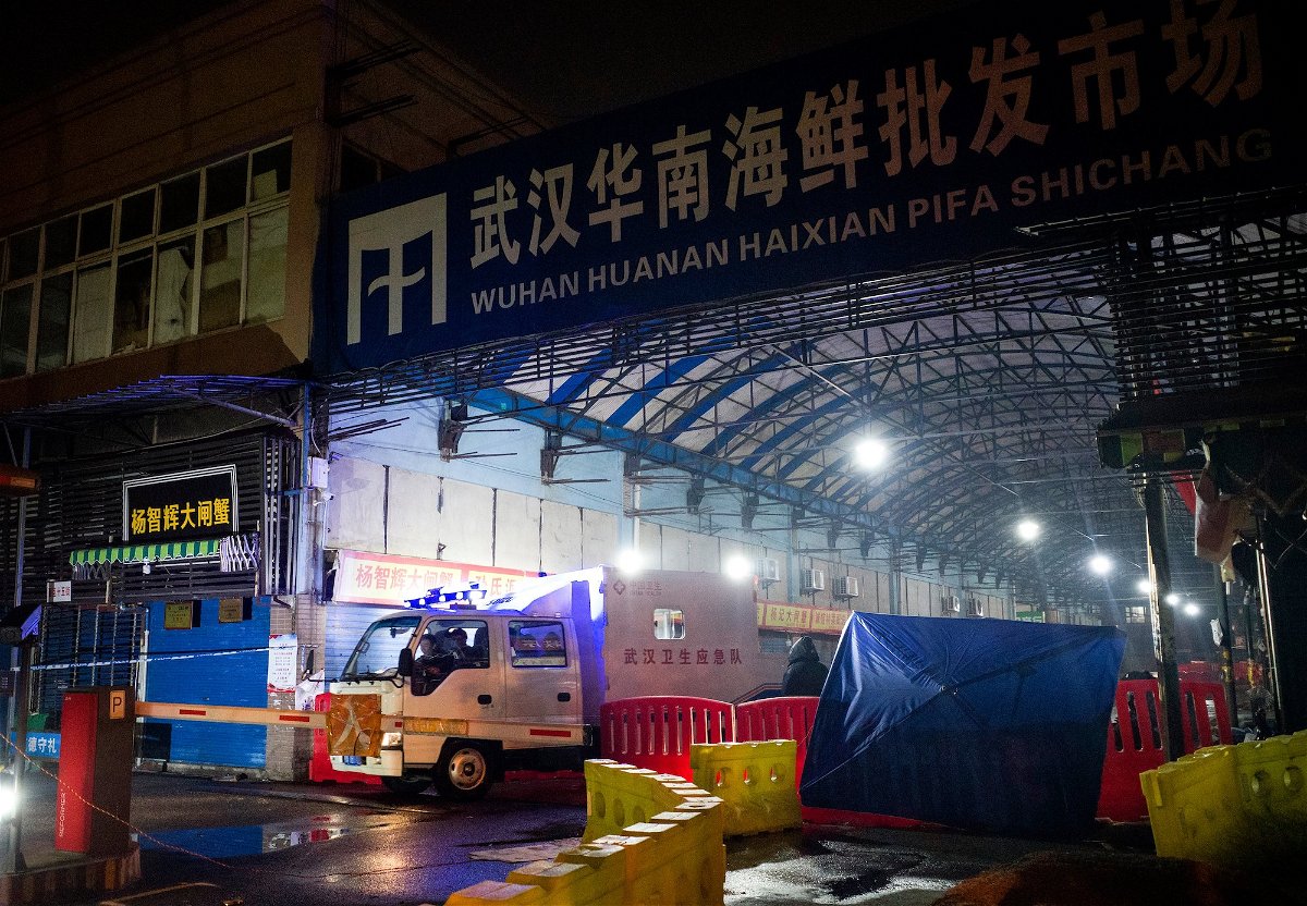 <i>Noel Celis/AFP/Getty Images/FILE</i><br/>Staff members of the Wuhan Hygiene Emergency Response Team drive their vehicle as they leave the closed Huanan Seafood Wholesale Market in the city of Wuhan