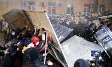 Protesters clash with police outside parliament building during a protest against bill on foreign influence transparency in Tbilisi