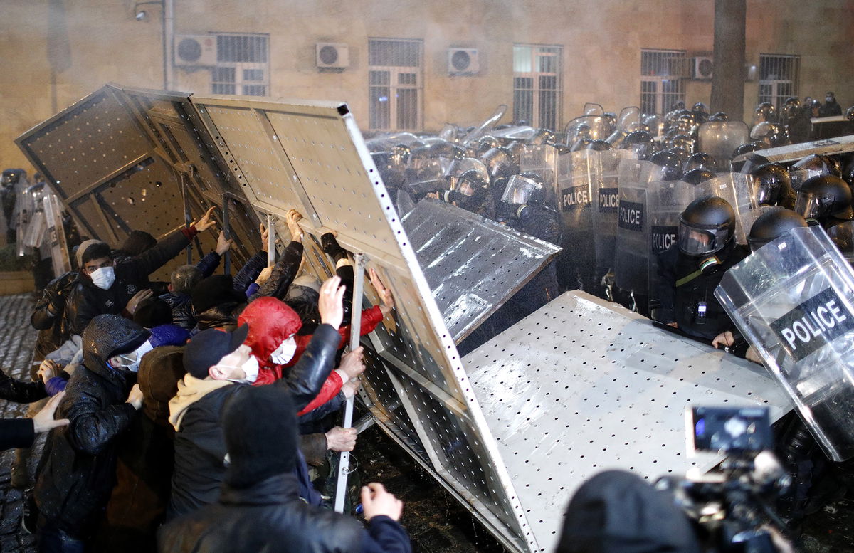 <i>David Mdzinarishvili/Anadolu Agency/Getty Images</i><br/>Protesters clash with police outside parliament building during a protest against bill on foreign influence transparency in Tbilisi