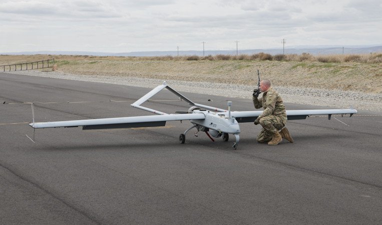 Oregon Army National Guard Staff Sgt. Timothy Powers completes post flight operations with an RQ-7B Shadow Tactical Unmanned Aircraft System after it landed during a demonstration flight as part of the official opening of the Unmanned Aerial System Operating Facility in Boardman
