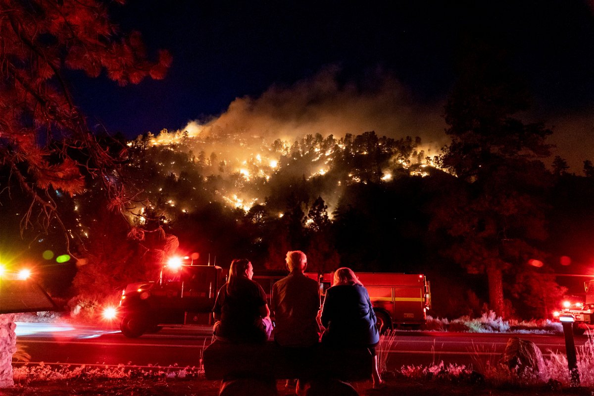 <i>Kyle Grillot/Reuters</i><br/>Residents watch part of the Sheep Fire wildfire burn through a forest on a hillside near their homes in Wrightwood