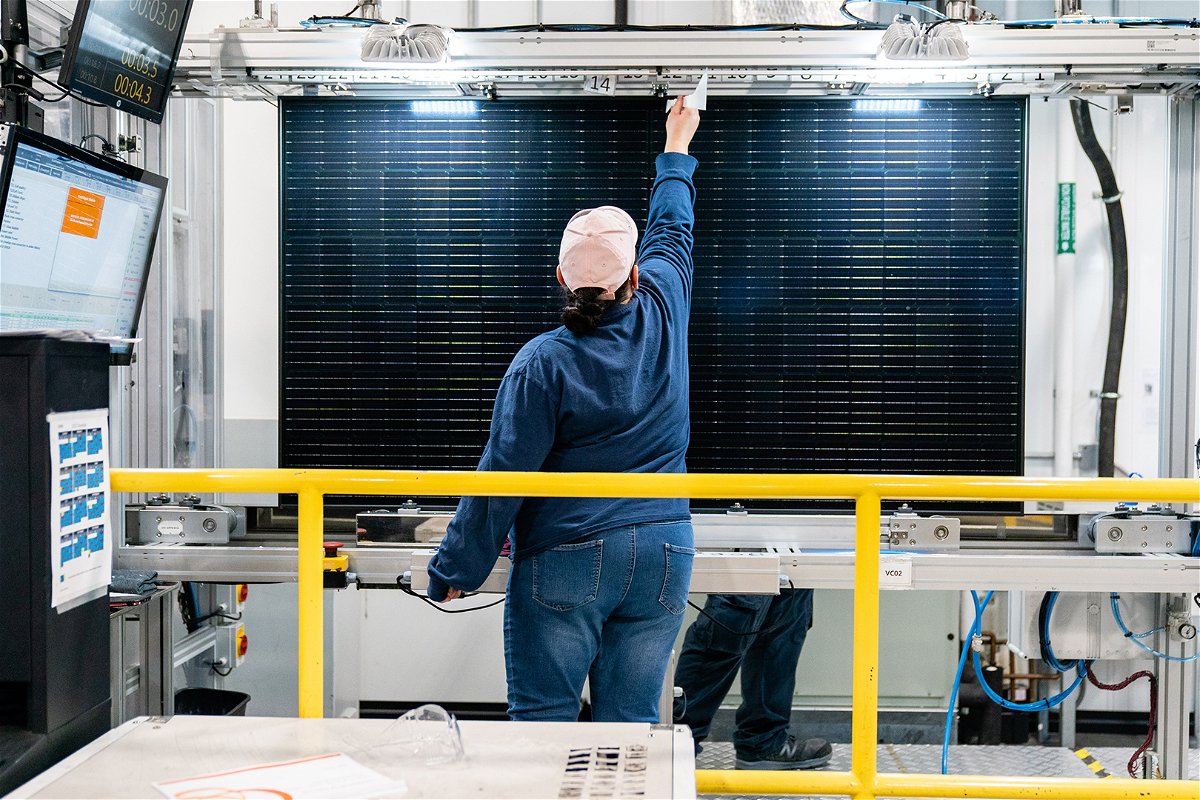 <i>Elijah Nouvelage/Bloomberg/Getty Images</i><br/>A quality control worker checks a solar panel at the Hanwha QCells solar cell and module manufacturing facility in Dalton