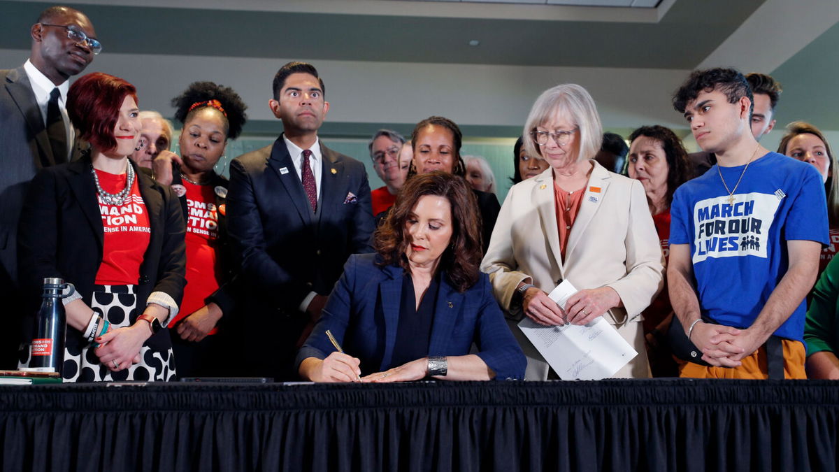 <i>Al Goldis/Detroit News via AP</i><br/>Michigan Gov. Gretchen Whitmer signs a package of gun bills on April 13