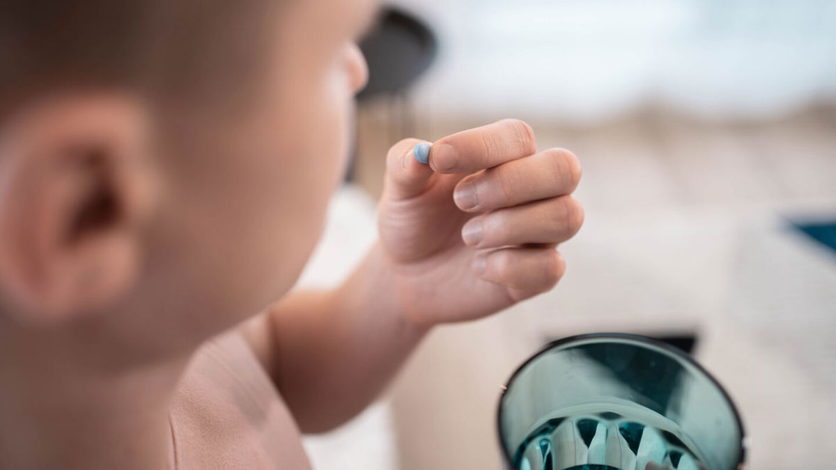 <i>Adobe Stock</i><br/>A young man takes a PrEP pill.