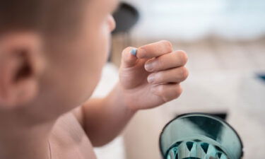 A young man takes a PrEP pill.