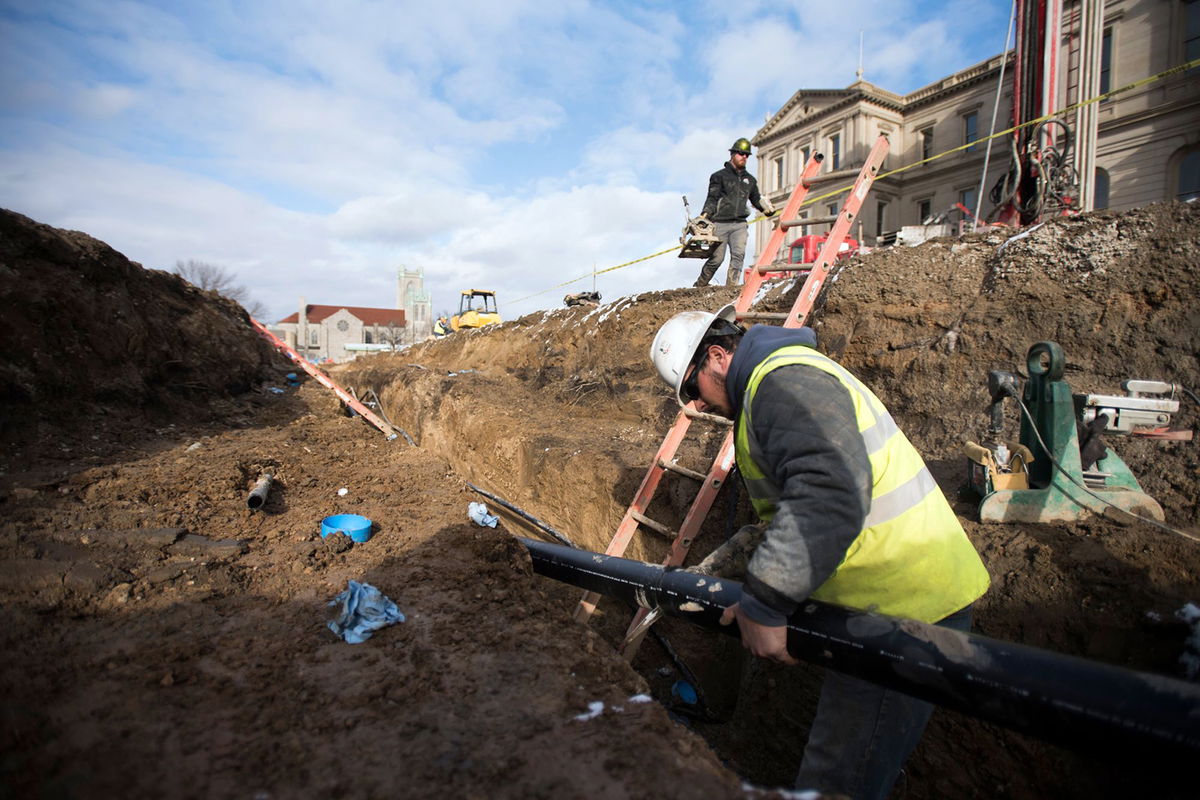 <i>Matthew Dae Smith/Lansing State Journal/USA Today Network/File</i><br/>A worker for a geothermal heating and cooling company works in Lansing