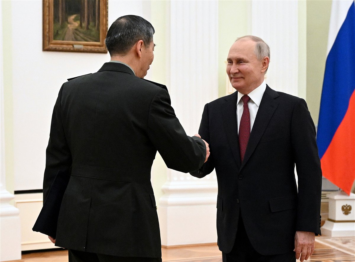 <i>Pavel Bednyakov/Sputnik/AP</i><br/>Russian President Vladimir Putin and Chinese Defense Minister Gen. Li Shangfu shake hands during their meeting at the Kremlin in Moscow