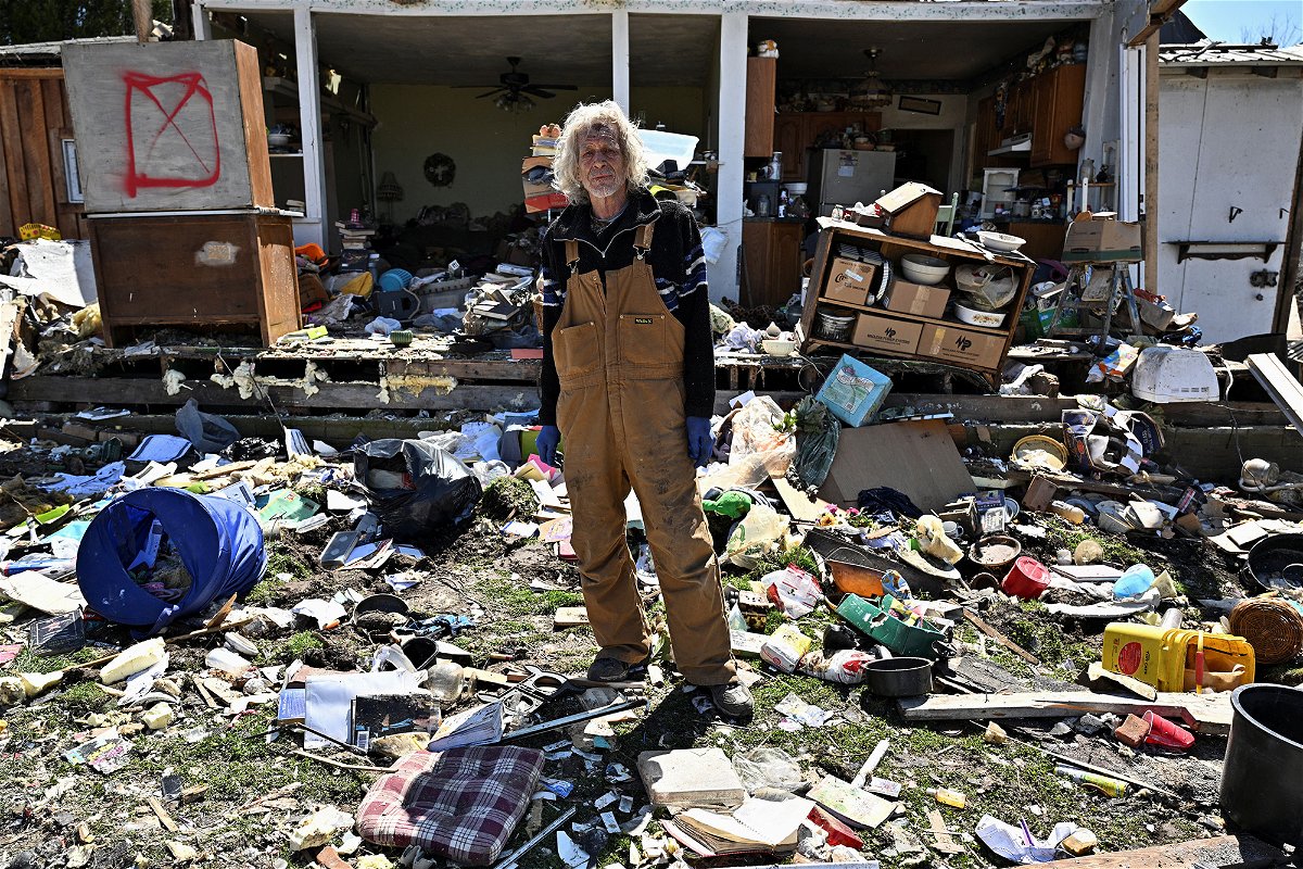 <i>Jon Cherry/Reuters</i><br/>Calvin Cox stands in front of his destroyed home