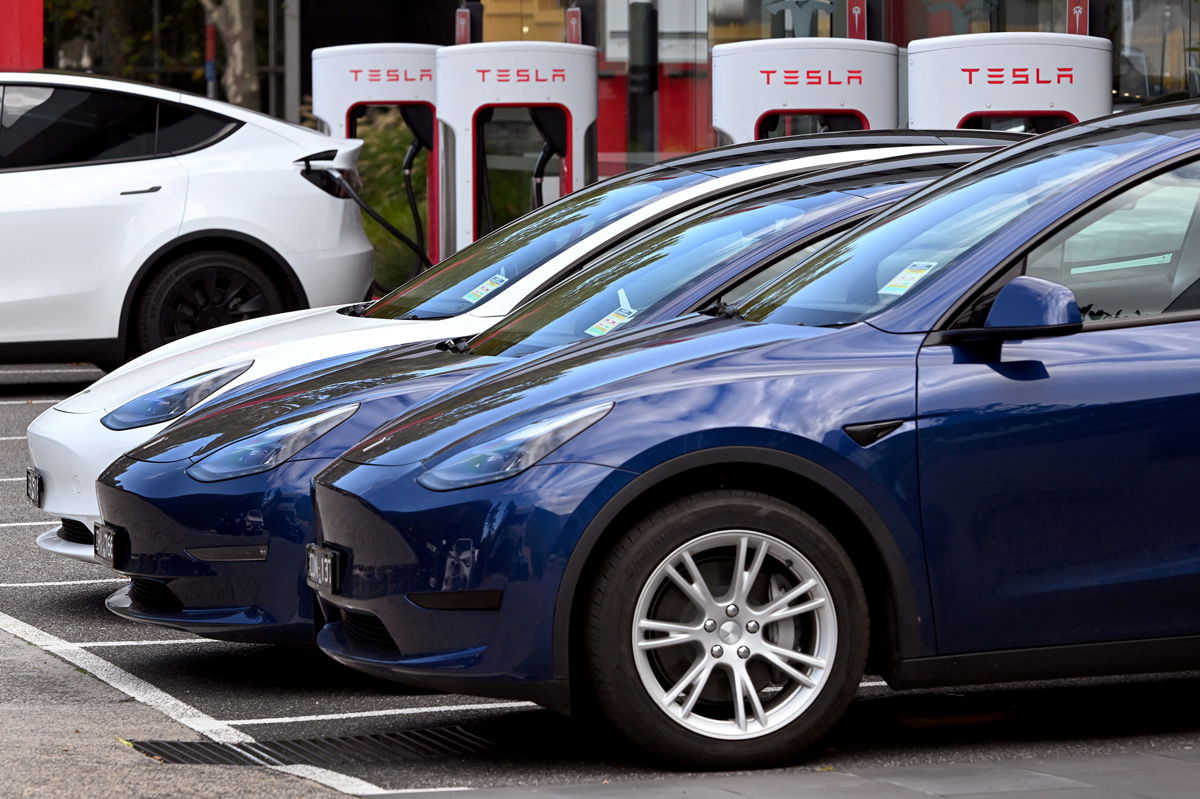 <i>William  West/AFP/Getty Images</i><br/>Electric vehicles (EV) line up outside a Tesla dealership in Melbourne