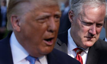 Then-President Donald Trump speaks as White House chief of staff Mark Meadows listens prior to Trump's Marine One departure from the South Lawn of the White House on July 29