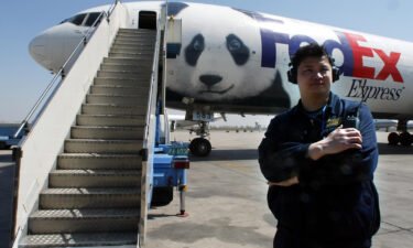 A Chinese airport official stands near the Panda Express