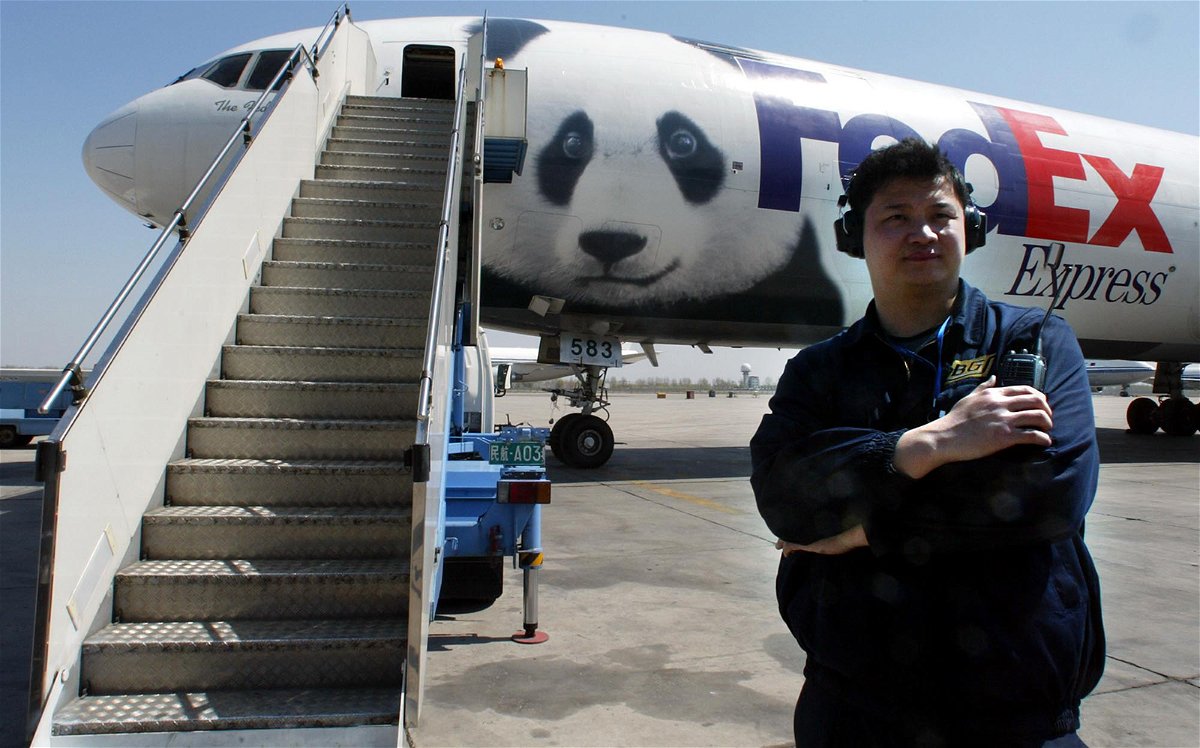 <i>NG HAN GUAN/AP</i><br/>A Chinese airport official stands near the Panda Express