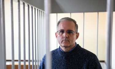 Paul Whelan stands inside a defendants' cage during a hearing at a court in Moscow on August 23