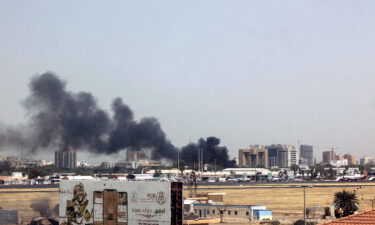 Heavy smoke bellows above buildings in the vicinity of the Khartoum's airport on April 15