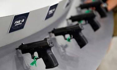 Guns are seen on display in trade booths during the National Rifle Association's annual meeting in Louisville