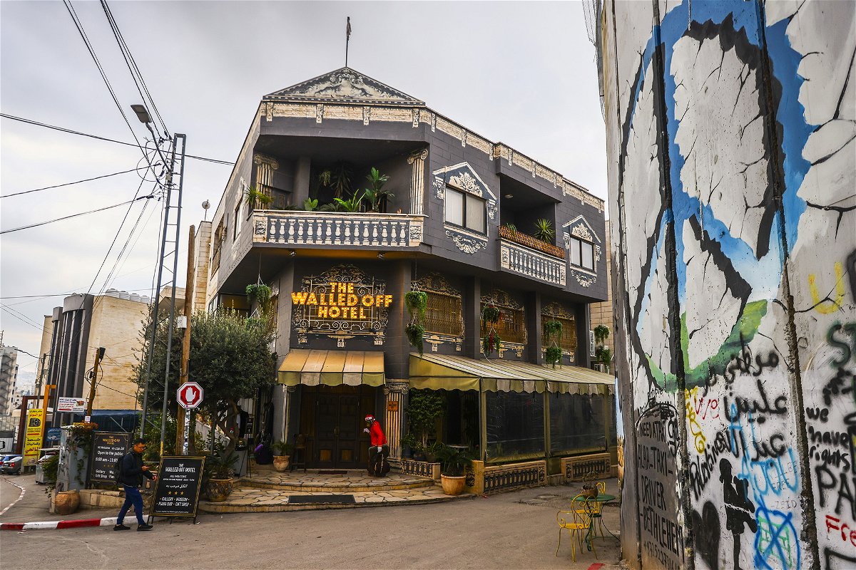 <i>Beata Zawrzel/NurPhoto/Getty Images</i><br/>A view of Banksy's 'The Walled Off Hotel' next to the Israeli separation barrier in Israeli-occupied Bethlehem on December 28