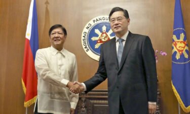 Philippine President Ferdinand Marcos Jr. shakes hands with Chinese Foreign Minister Qin Gang during a meeting in Manila on April 22.