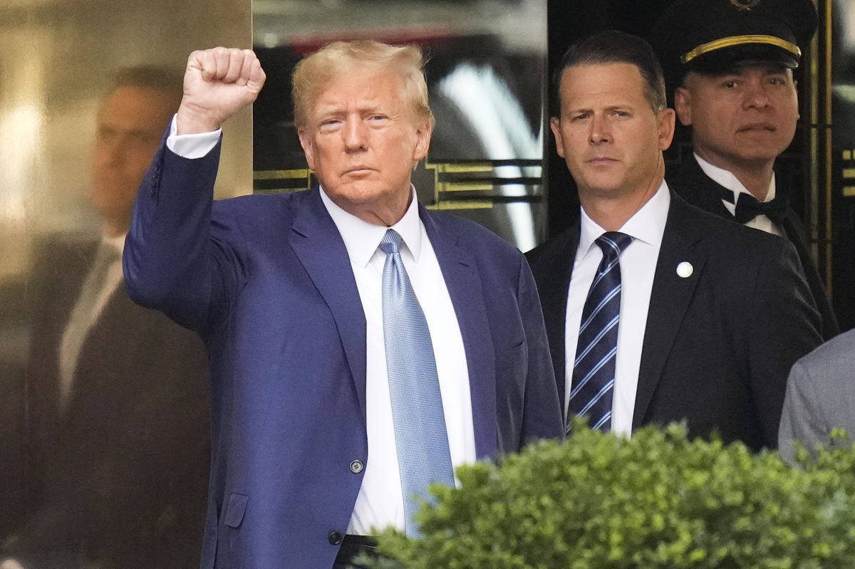 <i>Seth Wenig/AP</i><br/>Former President Donald Trump reacts as he leaves his apartment building in New York on Thursday