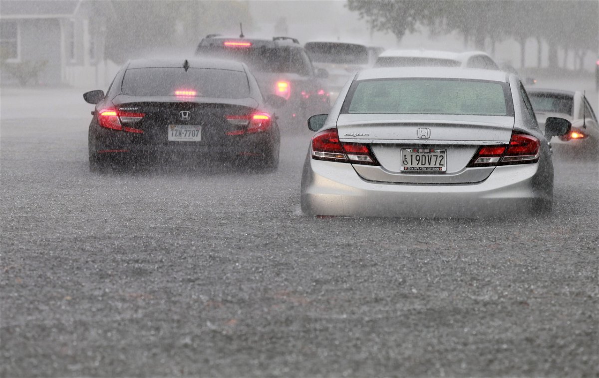 <i>Joe Raedle/Getty Images</i><br/>Cars are parked in a flooded street Wednesday in Dania Beach