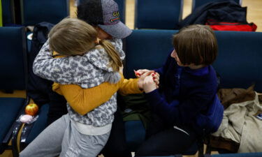 Anastasiia holds her daughter Valeriia and son Maksym in Kyiv