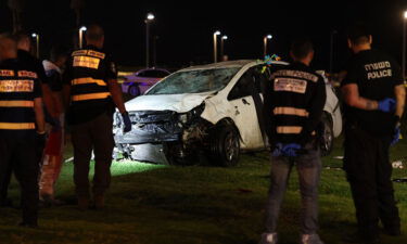 Israeli police gather next to a car used in a ramming attack in Tel Aviv on April 7.