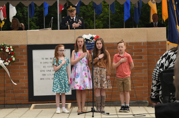 Children of Willamette National Cemetery employees and audience lead the Pledge of Allegiance during the opening of Memorial Day ceremony held Monday at the Willamette National Cemetery in Clackamas 