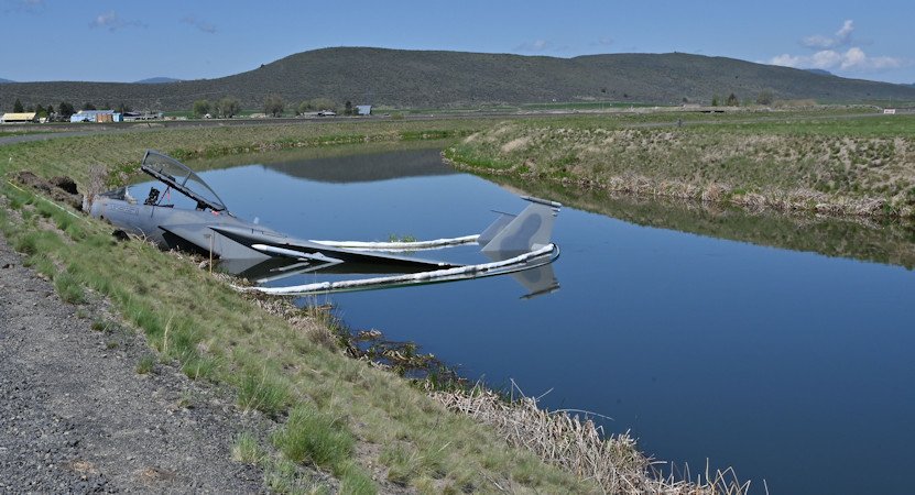 A U.S. Air Force F-15D assigned to the 173rd Fighter Wing sits in a Bureau of Reclamation canal on the south side of the runway following a mishap landing at Kingsley Field in Klamath Falls on Monday